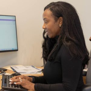 Woman typing at office desk